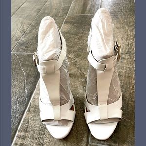 Stunning Aldo white patent leather with leather T-strap high heel sandals.